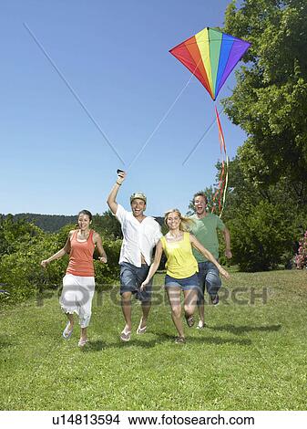 Friends flying a kite View Large Photo Image Picture - Friends flying a kite. Fotosearch
