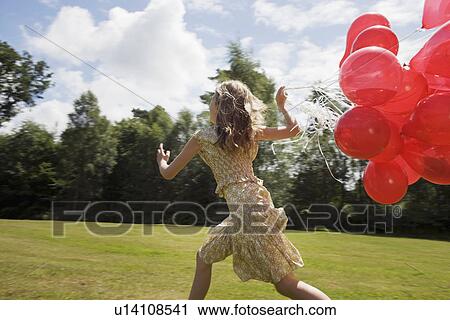 Girl holding bunch of red balloons View Large Photo Image Stock Image - Girl holding bunch of red balloons. Fotosearch