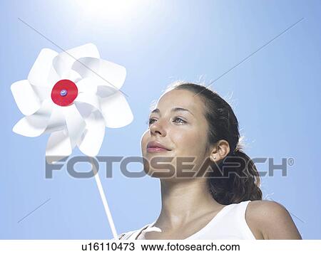 Girl holding windmill in sun View Large Photo Image Stock Image - Girl holding windmill in sun. Fotosearch