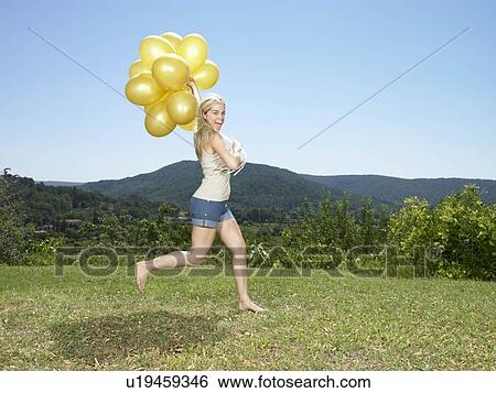 Girl running with balloons View Large Photo Image Stock Photograph - Girl running with balloons. Fotosearch