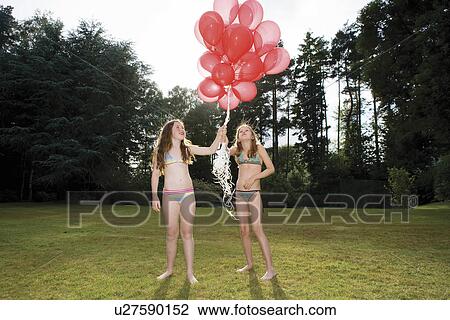 Two girls with red balloons View Large Photo Image Stock Image - Two girls with red balloons. Fotosearch