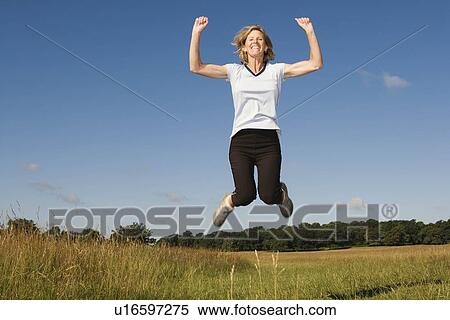 Stock Photography - Woman runner jumping in air. Fotosearch