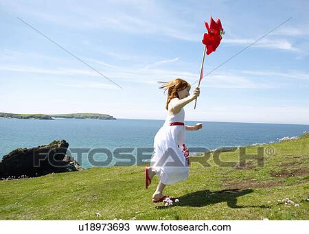 Young girl running with windmill View Large Photo Image Stock Image - Young girl running with windmill. Fotosearch