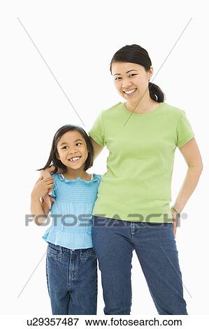 Asian mother and daughter standing with arms around eachother. View Large Photo Image Stock Photo - Asian mother and daughter standing with arms around eachother.. Fotosearch