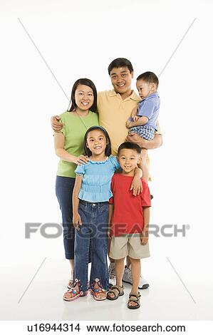 Picture - Asian parents with three children standing in front of white background.. Fotosearch