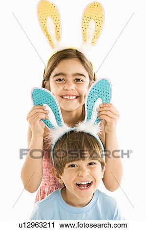 Boy and girl wearing rabbit ears smiling View Large Photo Image Stock Image - Boy and girl wearing rabbit ears smiling. Fotosearch