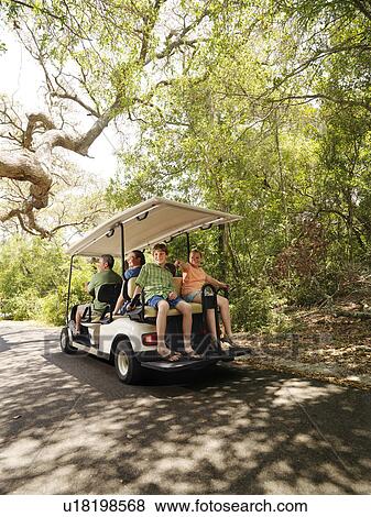 Caucasian family riding on golf cart on trail in North Carolina, USA. View Large Photo Image Stock Photo - Caucasian family riding on golf cart on trail in North Carolina, USA.. Fotosearch