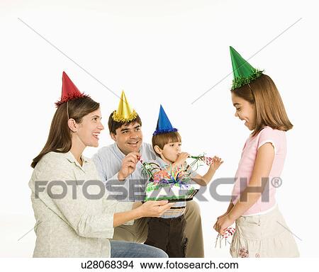 Picture - Family celebrating girl's birthday with cake.. Fotosearch