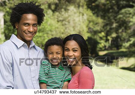 Family portrait of parents and young son smiling View Large Photo Image Stock Photo - Family portrait of parents and young son smiling. Fotosearch