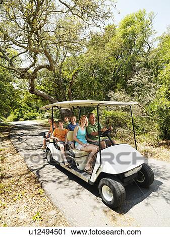 Family riding on golf cart on trail in North Carolina, USA View Large Photo Image Stock Image - Family riding on golf cart on trail in North Carolina, USA. Fotosearch