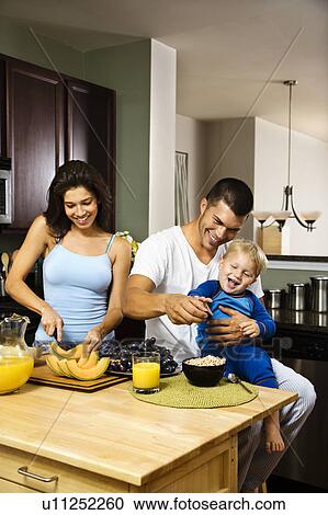 Family with toddler in kitchen at breakfast View Large Photo Image Stock Image - Family with toddler in kitchen at breakfast. Fotosearch