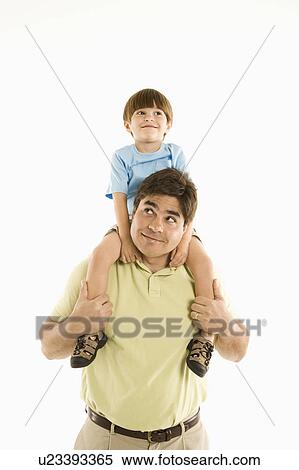 Stock Photography - Father holding son on shoulders standing against white background.. Fotosearch
