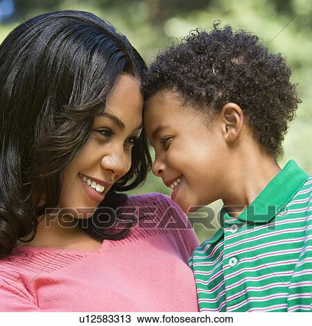 Stock Image - Happy smiling mother and young son portrait.. Fotosearch