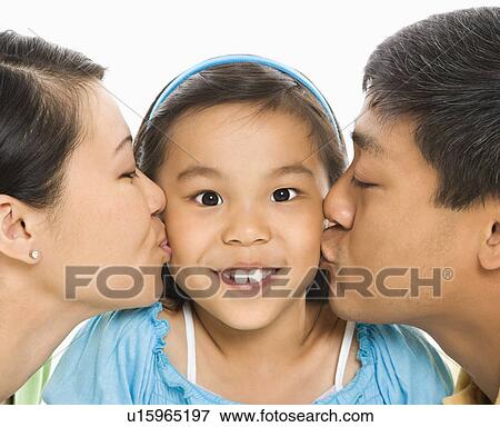Mother and father kissing opposite cheeks of daughter View Large Photo Image Stock Photo - Mother and father kissing opposite cheeks of daughter. Fotosearch
