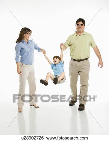 Stock Photograph - Mother and father swinging son . Fotosearch