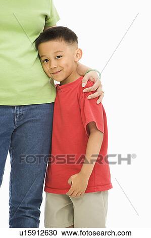 Mother standing with arm around son View Large Photo Image Stock Image - Mother standing with arm around son. Fotosearch