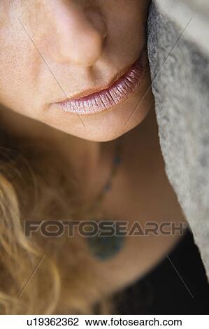 Close up of Caucasian female with face leaning against rock. View Large Photo Image Stock Image - Close up of Caucasian female with face leaning against rock.. Fotosearch