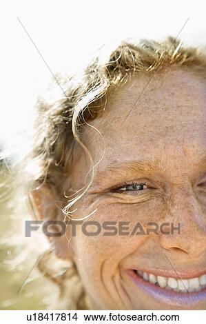 Picture - Close up of Caucasian mid-adult woman with wavy hair smilng.. Fotosearch