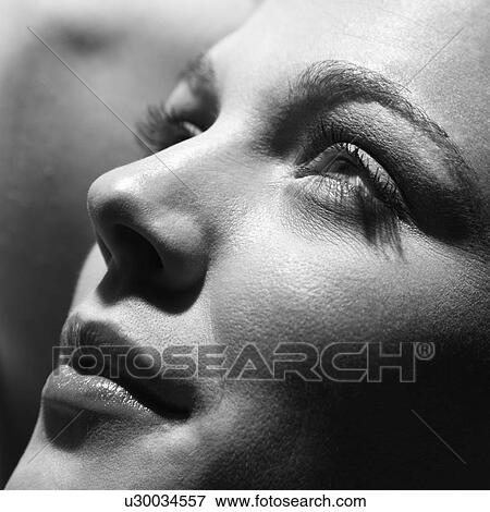 Stock Photo - Close-up of young Caucasian woman face looking to side.. Fotosearch