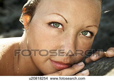 Picture - Close-up of young Caucasian woman's face with wet hair.. Fotosearch