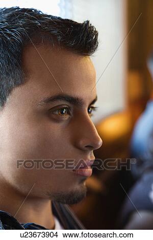 Close-up portrait of serious young hispanic man. View Large Photo Image Picture - Close-up portrait of serious young hispanic man.. Fotosearch