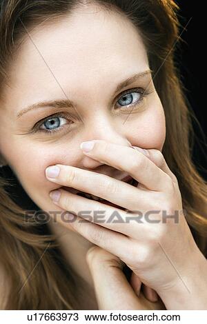 Close up portrait of young adult caucasian female laughing with hand over mouth. View Large Photo Image Stock Image - Close up portrait of young adult caucasian female laughing with hand over mouth.. Fotosearch