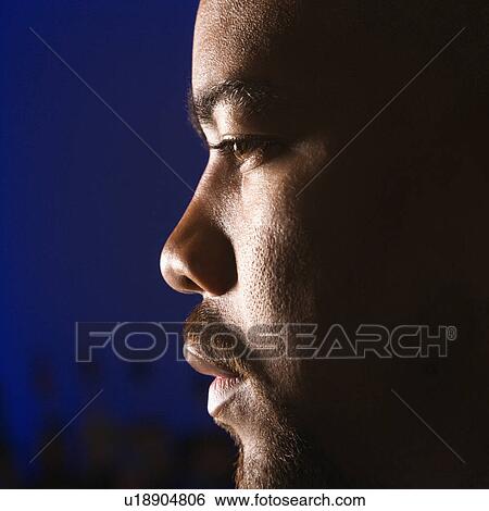 Close up profile of African American man in bar against glowing blue background. View Large Photo Image Stock Photograph - Close up profile of African American man in bar against glowing blue background.. Fotosearch