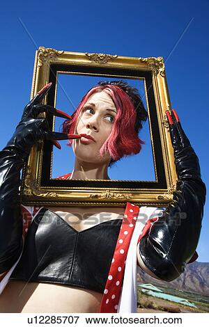 Stock Photo - Female holding empty frame around head. Fotosearch