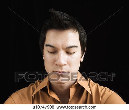 Stock Photo - Man sitting meditating. Fotosearch