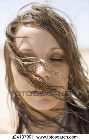 Portrait of Caucasian mid-adult woman with hair blowing across face. View Large Photo Image Stock Image - Portrait of Caucasian mid-adult woman with hair blowing across face.. Fotosearch