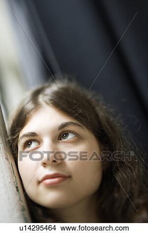 Picture - Selective focus of Caucasian young adult woman looking up.. Fotosearch