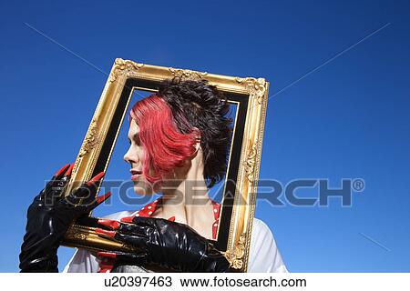 Young adult Caucasian female holding empty frame around head. View Large Photo Image Stock Image - Young adult Caucasian female holding empty frame around head.. Fotosearch
