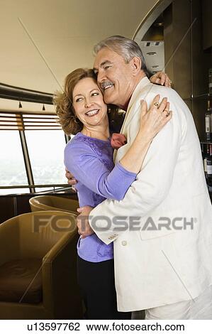 Couple embracing and smiling View Large Photo Image Stock Image - Couple embracing and smiling. Fotosearch