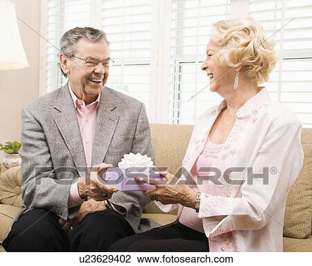 Couple exchanging present View Large Photo Image Stock Image - Couple exchanging present. Fotosearch
