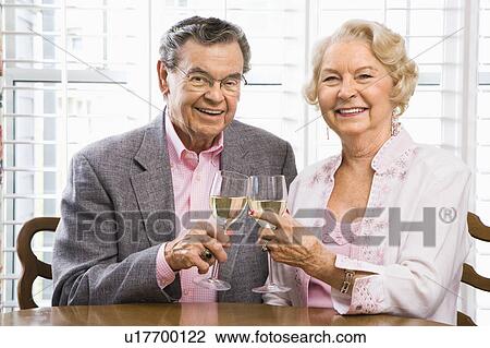 Couple toasting wine glasses View Large Photo Image Stock Image - Couple toasting wine glasses. Fotosearch