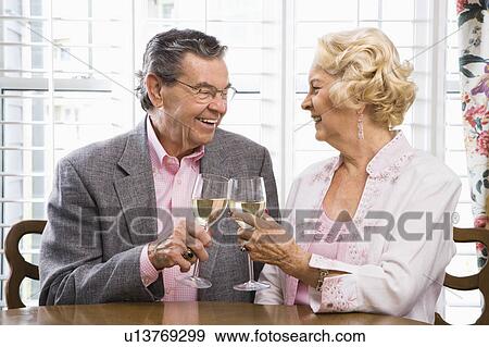Stock Photo - Couple toasting wine glasses. Fotosearch