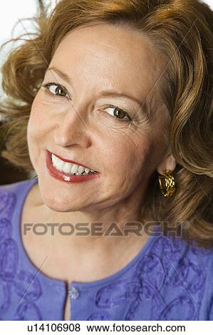 Stock Photo - Head and shoulder portrait of smiling middle aged Caucasian woman.. Fotosearch