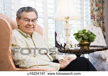 Stock Photo - Man sitting in chair. Fotosearch