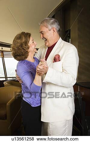 Stock Photo - Mature Caucasian couple dancing and laughing.. Fotosearch