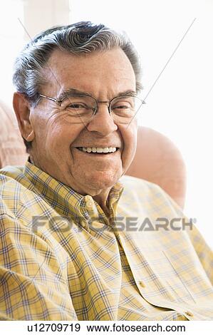 Stock Photo - Portrait of mature Caucasian man sitting in chair.. Fotosearch