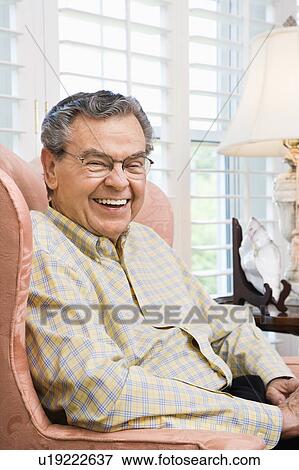 Portrait of mature Caucasian man sitting in chair. View Large Photo Image Stock Photo - Portrait of mature Caucasian man sitting in chair.. Fotosearch