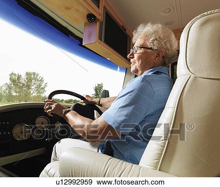 Senior adult woman driving RV and smiling. View Large Photo Image Stock Photo - Senior adult woman driving RV and smiling.. Fotosearch