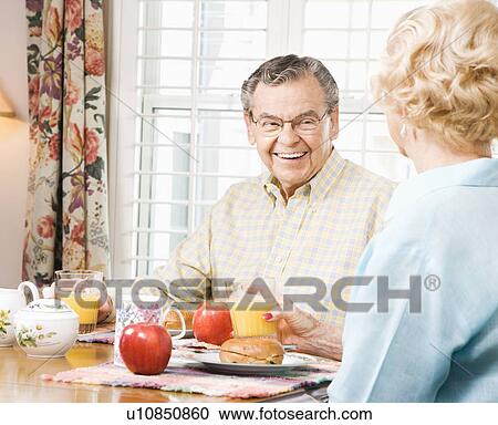 Senior couple having breakfast together View Large Photo Image Stock Image - Senior couple having breakfast together. Fotosearch