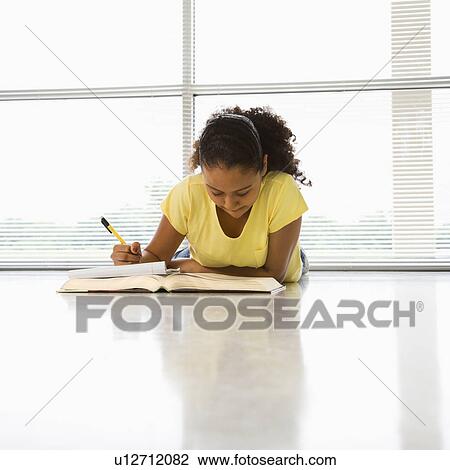 African American girl lying on floor doing homework. View Large Photo Image Stock Image - African American girl lying on floor doing homework.. Fotosearch