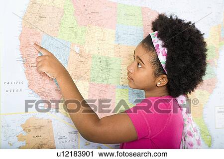 Stock Image - African American girl pointing on map of United States.. Fotosearch