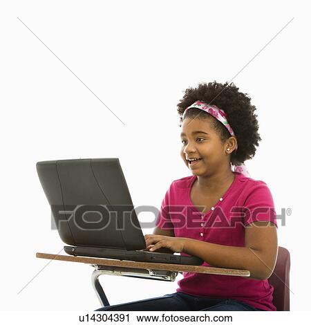 African American girl sitting in school desk typing on laptop computer. View Large Photo Image Stock Image - African American girl sitting in school desk typing on laptop computer.. Fotosearch