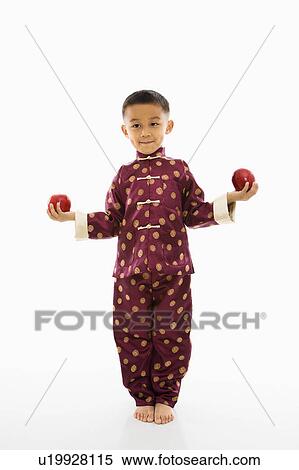 Boy in traditional attire standing with red apple in each hand. View Large Photo Image Stock Photography - Boy in traditional attire standing with red apple in each hand.. Fotosearch