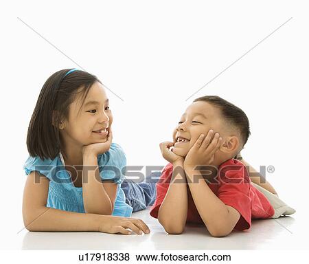 Stock Photo - Brother and sister lying on floor . Fotosearch