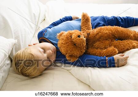 Caucasian toddler boy sleeping in bed with teddy bear. View Large Photo Image Stock Photo - Caucasian toddler boy sleeping in bed with teddy bear.. Fotosearch
