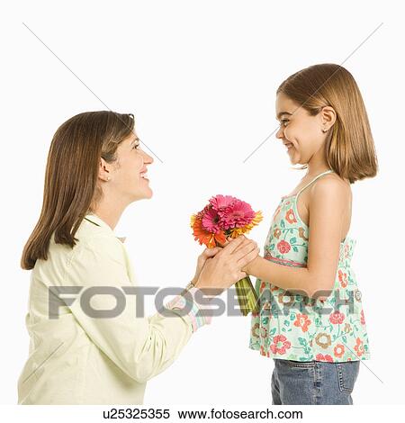 Girl giving bouquet of flowers to mother View Large Photo Image Stock Photography - Girl giving bouquet of flowers to mother. Fotosearch